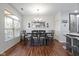 Bright dining room featuring a stylish chandelier, large window, and seating for six at 11339 Fonthill Dr, Indianapolis, IN 46236