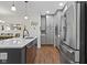 The kitchen features stainless steel appliances, a stylish backsplash, gray cabinets, and an island with bar seating at 11339 Fonthill Dr, Indianapolis, IN 46236