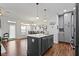The kitchen features a gray island with sink, quartz countertop, and stainless steel appliances in an open layout at 11339 Fonthill Dr, Indianapolis, IN 46236