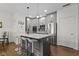 A modern kitchen featuring gray cabinets, stainless steel appliances, a central island, and wood-look flooring at 11339 Fonthill Dr, Indianapolis, IN 46236