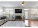 Bright and airy living room with a stone fireplace, large windows, and a neutral color scheme at 11339 Fonthill Dr, Indianapolis, IN 46236