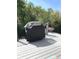 Enjoy grilling outdoors on this home's back deck with wooded views and a nice grill at 11863 Edgefield Dr, Fishers, IN 46037