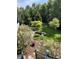 Lush backyard featuring manicured landscaping, decorative trees, and healthy green grass at 11863 Edgefield Dr, Fishers, IN 46037