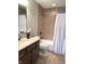 Bathroom with tiled shower, neutral countertop and dark wood cabinets at 11863 Edgefield Dr, Fishers, IN 46037