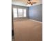 Bedroom featuring neutral carpet, a ceiling fan and large window at 11863 Edgefield Dr, Fishers, IN 46037
