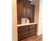 This butler's pantry features plenty of storage with the beautiful wood cabinets and white marble counter at 11863 Edgefield Dr, Fishers, IN 46037