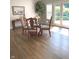 Dining room featuring wood floors, a glass table and views of the backyard at 11863 Edgefield Dr, Fishers, IN 46037