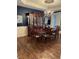 A formal dining room with a chandelier, a large wood table and chairs, and a china cabinet at 11863 Edgefield Dr, Fishers, IN 46037