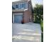 A cement driveway with a 2 car garage and a well manicured garden along the fence and some red flowers at 11863 Edgefield Dr, Fishers, IN 46037
