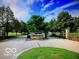 Arbor Glen gated entrance featuring stone pillars, flower bed, and lush landscaping at 11863 Edgefield Dr, Fishers, IN 46037