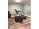 Home exercise room featuring hardwood floors and an assortment of workout equipment at 11863 Edgefield Dr, Fishers, IN 46037