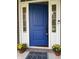 Welcoming blue front door with sidelights and yellow mums creating an inviting entrance to the home at 11863 Edgefield Dr, Fishers, IN 46037