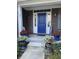 Charming front entrance with a blue door framed by sidelights, flanked by flowers, and a welcoming porch at 11863 Edgefield Dr, Fishers, IN 46037