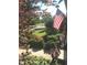 View of the front yard featuring American flags, mature trees, and well-maintained landscaping at 11863 Edgefield Dr, Fishers, IN 46037