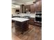 Kitchen featuring a center island with white countertop, wooden cabinets, tile backsplash and stainless steel appliances at 11863 Edgefield Dr, Fishers, IN 46037