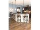 Kitchen featuring a bar with seating, wood floors and modern appliances at 11863 Edgefield Dr, Fishers, IN 46037