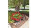 Lush landscaping featuring a large flower pot with red flowers adding color to the front yard at 11863 Edgefield Dr, Fishers, IN 46037