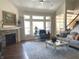 Spacious living room featuring fireplace, large windows, high ceilings, hardwood floors and comfortable seating at 11863 Edgefield Dr, Fishers, IN 46037