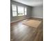 Sun-lit living room boasting hardwood floors, neutral walls, and large windows at 11863 Edgefield Dr, Fishers, IN 46037