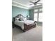 A tranquil main bedroom with a plush bed, a fan, and natural light from the windows at 11863 Edgefield Dr, Fishers, IN 46037