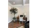 A home office with a decorative palm, traditional desk, and overhead lighting at 11863 Edgefield Dr, Fishers, IN 46037