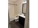 This is a bathroom featuring a tub with tile surround, dark vanity, and modern fixtures at 1254 Kenwood Dr, Greenwood, IN 46143