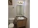 Bathroom with a single sink vanity, framed mirror, and a standard toilet at 1254 Kenwood Dr, Greenwood, IN 46143
