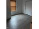 The bedroom has wood-look flooring, a window with blinds, and a closet at 1254 Kenwood Dr, Greenwood, IN 46143