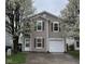Charming two-story home with neutral siding, garage, and flowering trees in a well-maintained yard at 1254 Kenwood Dr, Greenwood, IN 46143