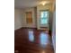 Bright living room featuring hardwood floors, a window with blinds, and an open doorway at 1254 Kenwood Dr, Greenwood, IN 46143