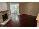 Open living room with fireplace and hardwood floors leading into the kitchen area at 1254 Kenwood Dr, Greenwood, IN 46143