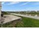 Spacious backyard with a scenic pond view, complemented by a patio and picnic table at 12722 Brady Ln, Noblesville, IN 46060