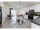 Bright kitchen with white cabinets, stainless steel appliances, and a dining area overlooking the backyard at 12722 Brady Ln, Noblesville, IN 46060