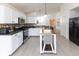 Bright kitchen features white cabinetry, stainless steel appliances, and a movable center island at 12722 Brady Ln, Noblesville, IN 46060