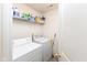 Functional laundry area featuring a washer, dryer, and shelving for ample storage at 12722 Brady Ln, Noblesville, IN 46060