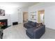 Bright living room with fireplace, featuring a comfortable gray sofa and modern decor at 12722 Brady Ln, Noblesville, IN 46060