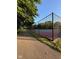 Fenced community tennis court with a black chain link fence and trees at 12722 Brady Ln, Noblesville, IN 46060