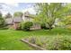 Backyard with a well-maintained lawn, mature trees, and a wooden deck, perfect for outdoor entertaining at 13778 Driftwood Dr, Carmel, IN 46033