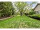 Lush backyard with mature trees and well-manicured lawn, creating a peaceful and private oasis at 13778 Driftwood Dr, Carmel, IN 46033