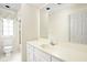 Bathroom featuring vanity, toilet, and shower with glass door and patterned wallpaper at 13778 Driftwood Dr, Carmel, IN 46033