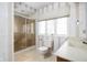 Cozy bathroom featuring a shower, toilet, sink, and patterned wallpaper at 13778 Driftwood Dr, Carmel, IN 46033