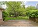 Wooden deck overlooking a manicured lawn with mature trees, providing a tranquil setting at 13778 Driftwood Dr, Carmel, IN 46033