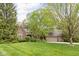 Charming two-story brick home with a well-manicured lawn and mature trees at 13778 Driftwood Dr, Carmel, IN 46033