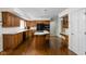 Traditional kitchen with wood cabinets, an island cooktop, and modern black appliances at 13778 Driftwood Dr, Carmel, IN 46033