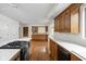 Spacious kitchen with an island cooktop, wood cabinets, and hardwood flooring at 13778 Driftwood Dr, Carmel, IN 46033