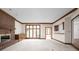 Spacious living room with a brick fireplace and large windows, creating a warm atmosphere at 13778 Driftwood Dr, Carmel, IN 46033