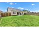 Backyard featuring a well-maintained lawn, a wooden fence, and a concrete patio at 1407 Allen Ct, Shelbyville, IN 46176