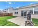 Backyard featuring a patio with a grill and fire pit, a grass lawn, and a perimeter fence at 1407 Allen Ct, Shelbyville, IN 46176