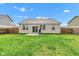 Large backyard featuring a grass lawn, a patio, and a full perimeter fence at 1407 Allen Ct, Shelbyville, IN 46176
