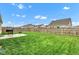 Spacious backyard with a well-maintained lawn, a wooden fence and a concrete patio at 1407 Allen Ct, Shelbyville, IN 46176